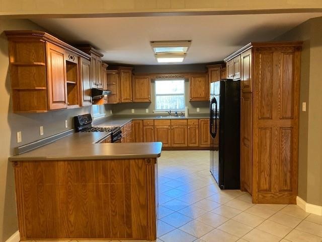 Kitchen with black appliances and tons of cabinest
