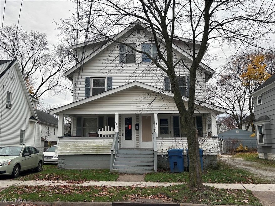 American foursquare style home featuring a porch