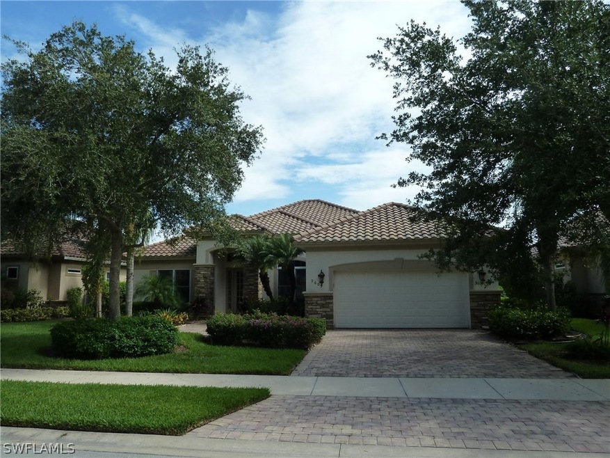 Front of home has brick paver driveway and walkway