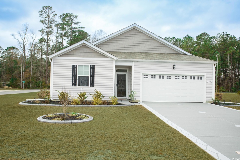 View of front facade with a front yard and a garag