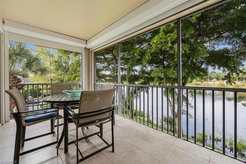 Sunroom / solarium featuring a water view