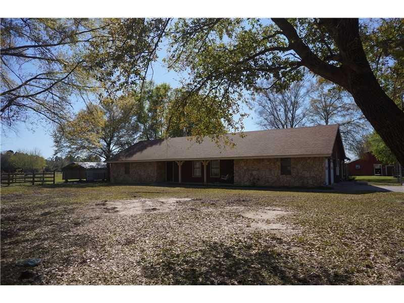 Exterior Front. Large shady oaks frame front of ho