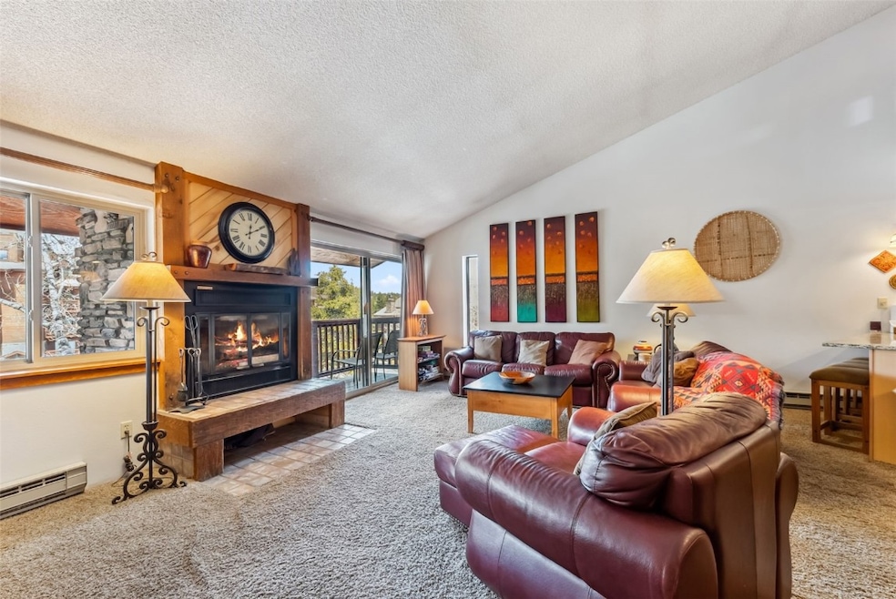 Living room featuring carpet flooring, vaulted cei
