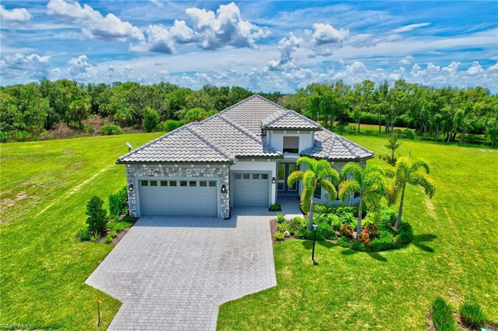 View of front of home featuring a garage and an ov