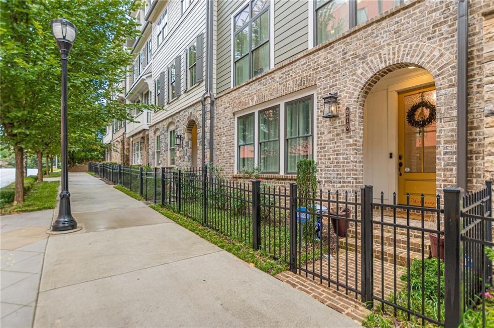 View of exterior entry with brick siding and fence