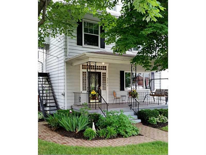 Exterior Front. Front porch shaded by mature Trees