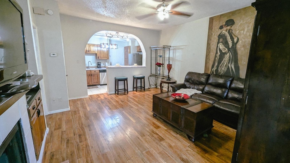 Living room with light hardwood / wood-style floor