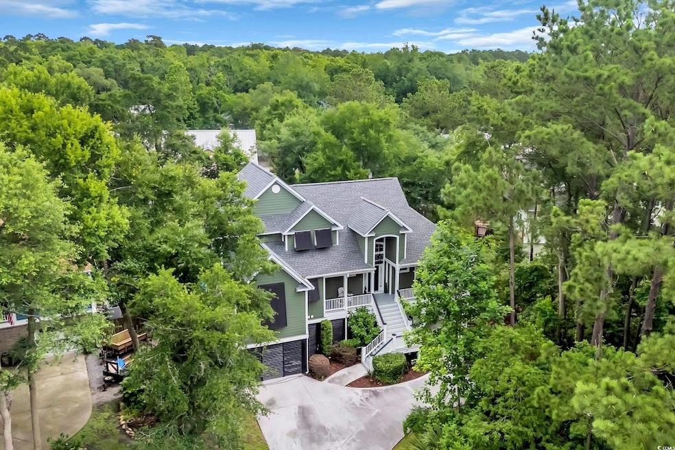 View of subject property with a forest