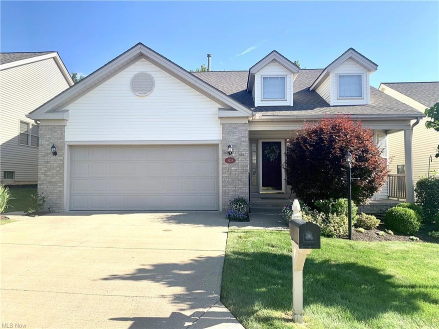 New england style home featuring garage and a front yard