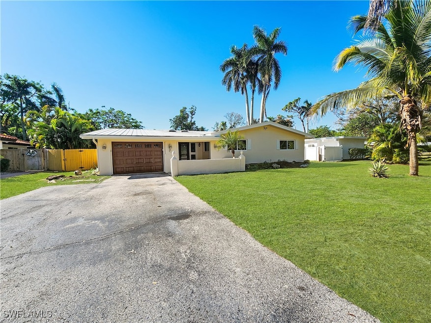 Ranch-style house with a garage and a front yard