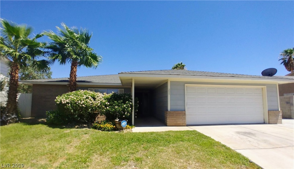 Property has a front grass yard and mature landsca