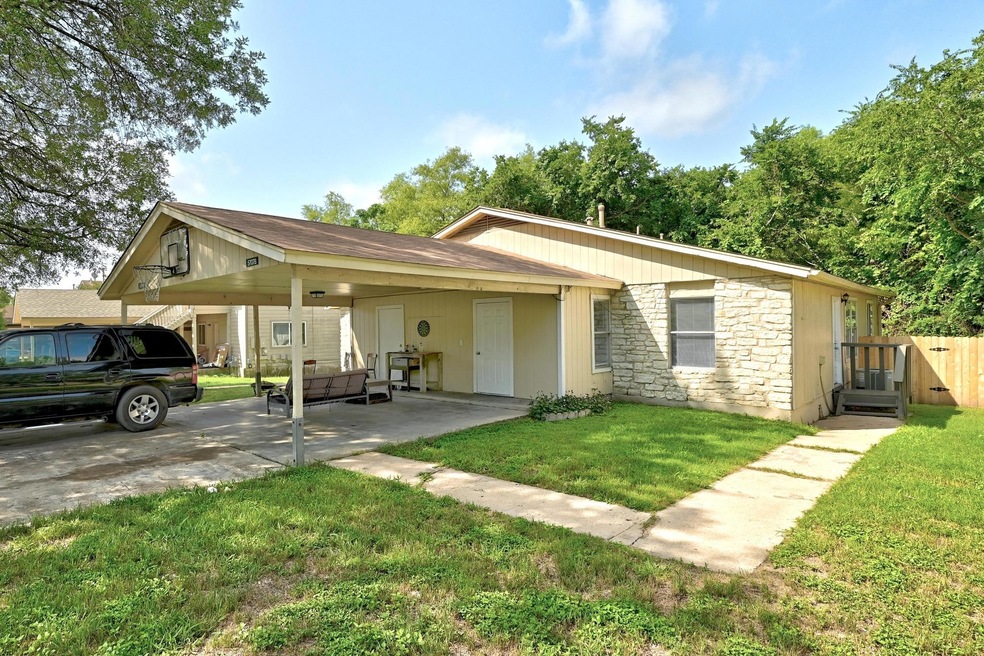 View of front of home featuring a carport and sto