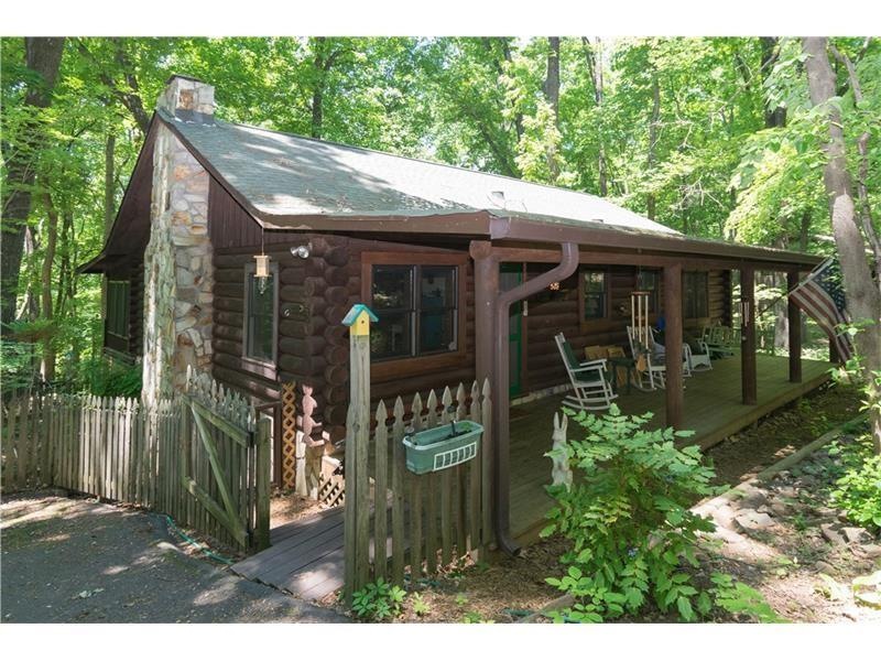Picture of cabin in the Spring with full foliage.