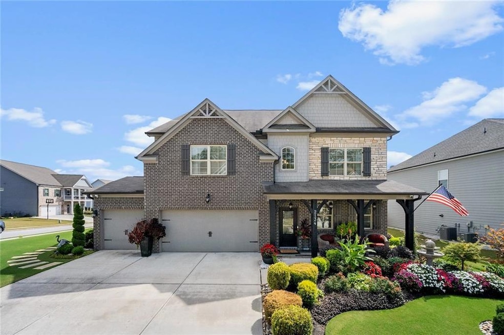 Craftsman-style house featuring stone siding, cent