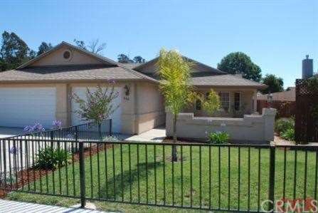 Front view with fenced front yard-notice 3 car gar