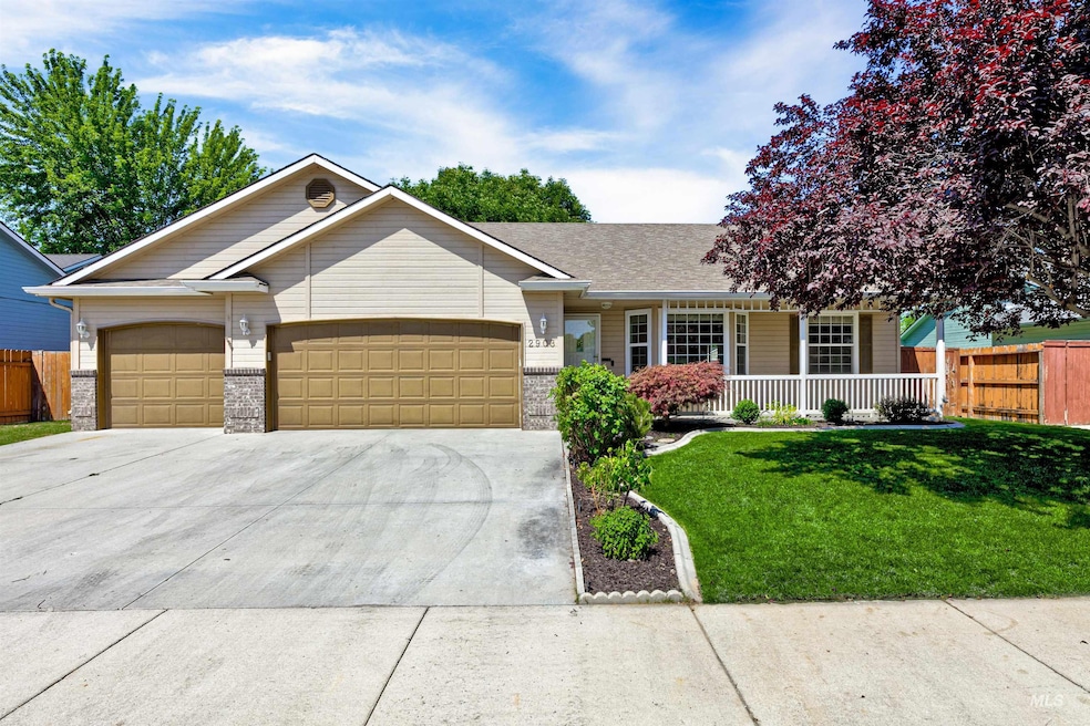 Ranch-style home with a porch, a garage, driveway, and brick siding