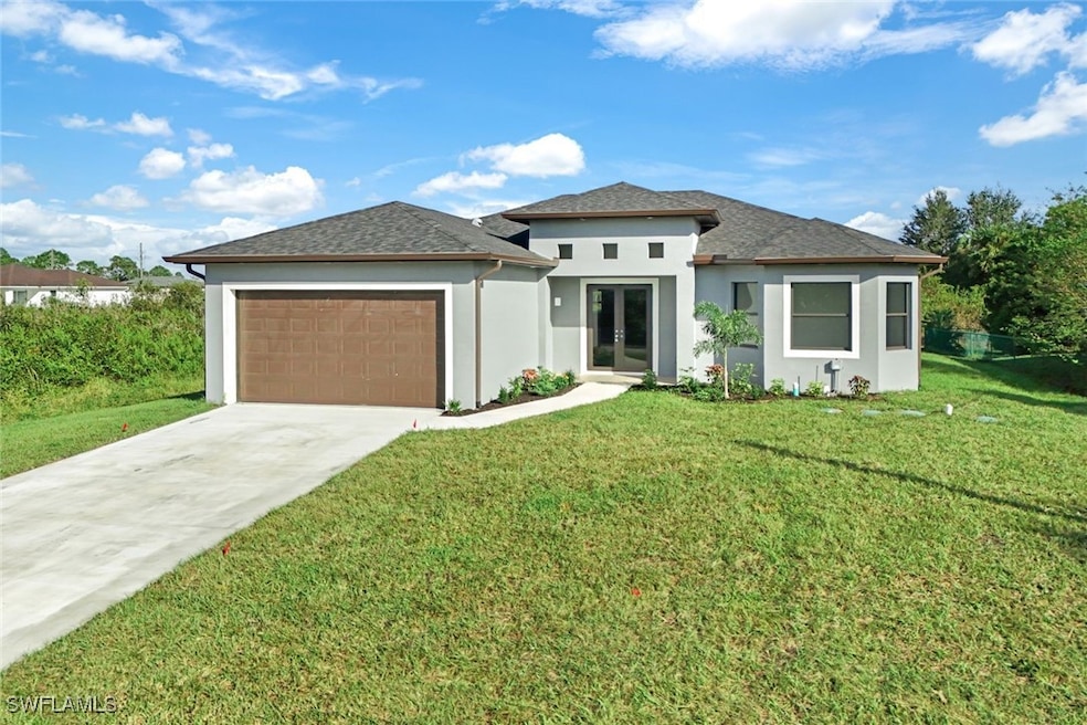 Prairie-style house with a front lawn and a garage