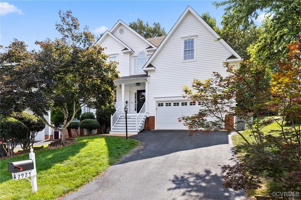 Traditional-style home with driveway, a garage, an