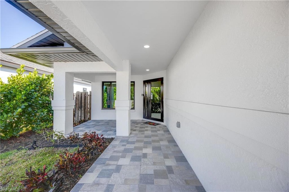 View of exterior entry with a patio area