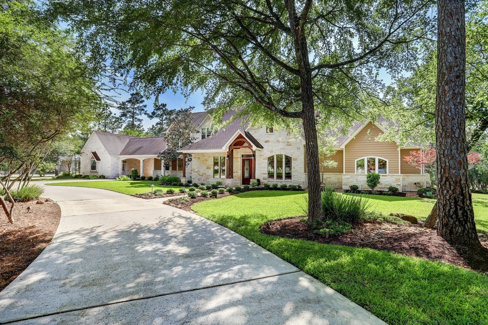 Warm stone and a dramatic roofline greet you from the driveway
