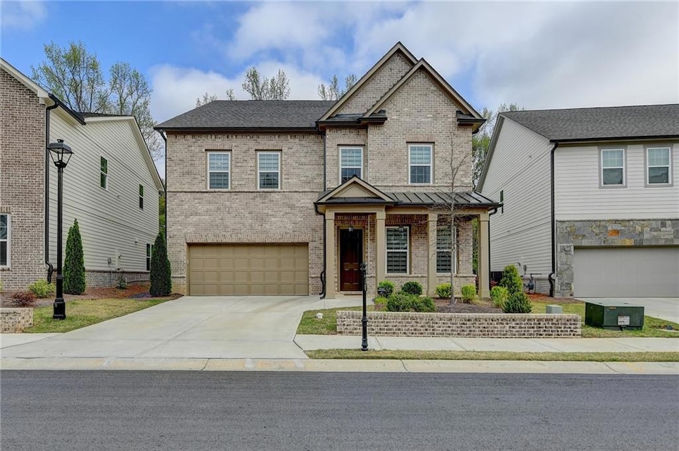 View of front of house featuring driveway, brick s