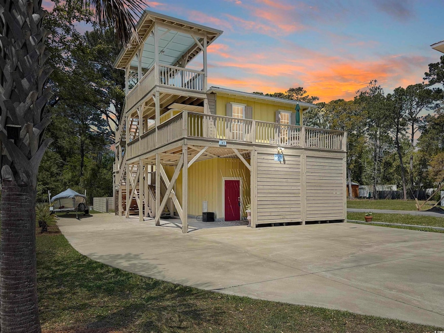 View of front facade with a carport, driveway, and
