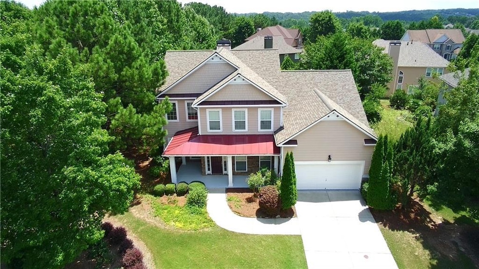 Craftsman inspired home featuring a porch, driveway, a shingled roof, a garage, and a metal roof
