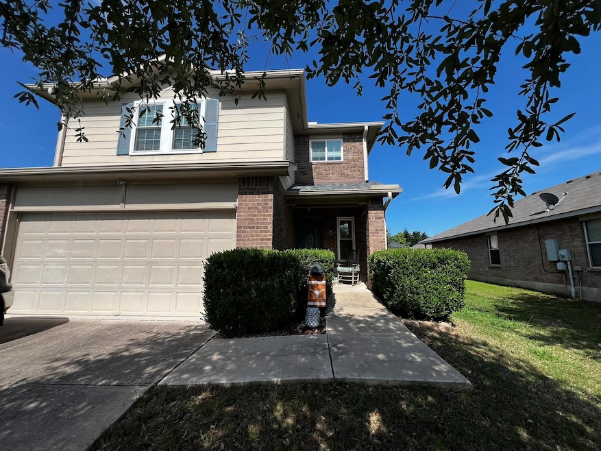 Traditional-style house with brick siding, a fron
