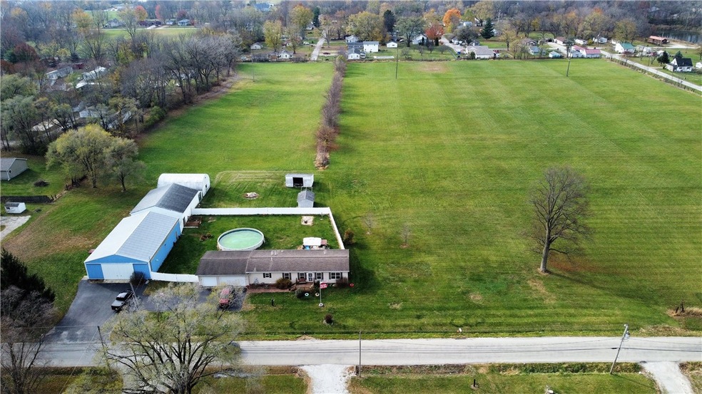 Above facing West.  Property is bordered by roads on three sides and treeline to the south