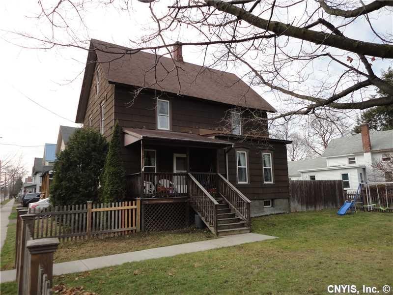 Exterior Front. Large, fenced-in front yard.