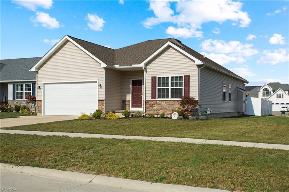 View of front of house with garage and a front law