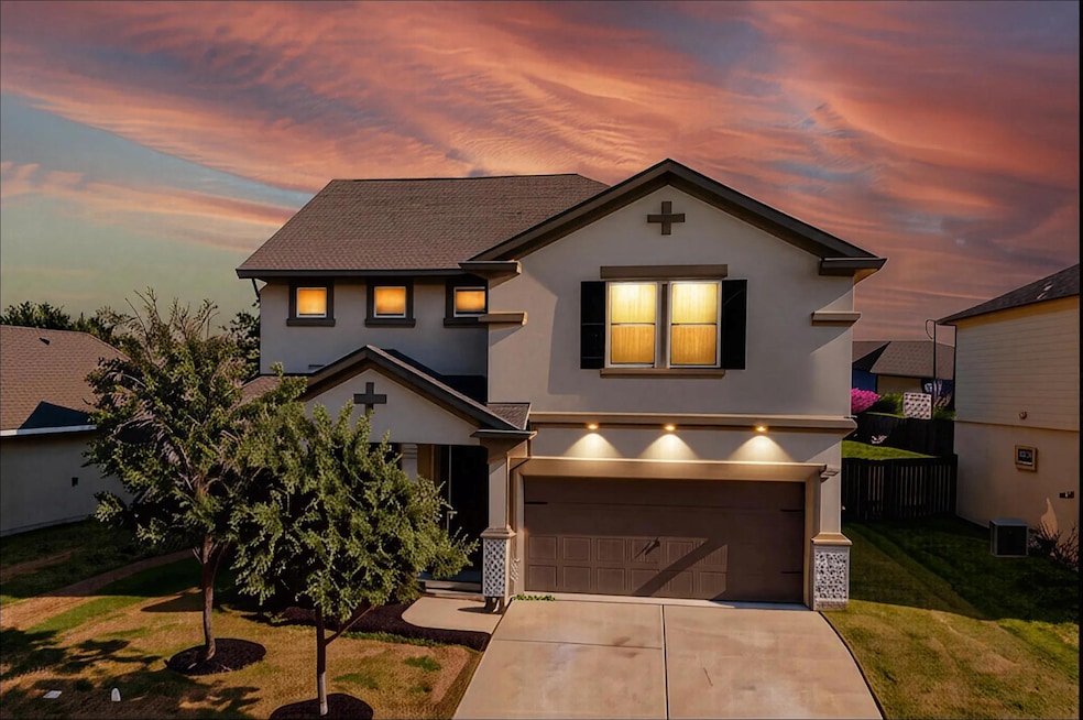 Traditional-style home with stucco siding, a garage, and concrete driveway