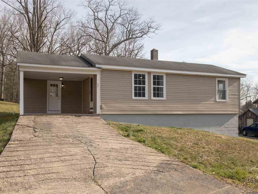 The front view of the home features a concrete dri