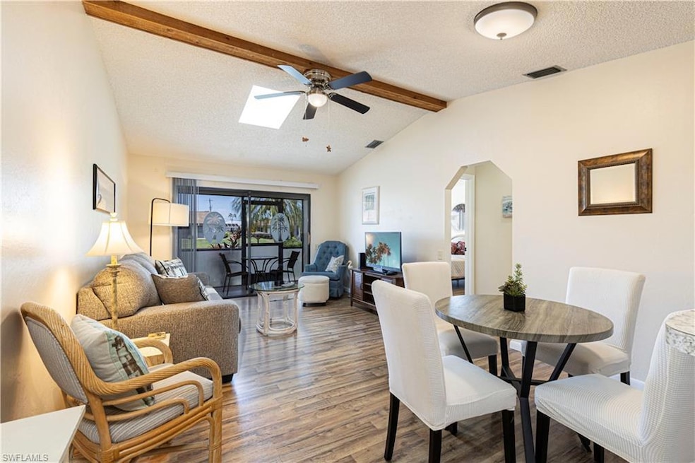 Dining space featuring vaulted ceiling with skylig