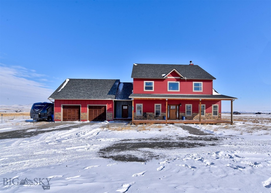 Front of home, the circle driveway is covered by t
