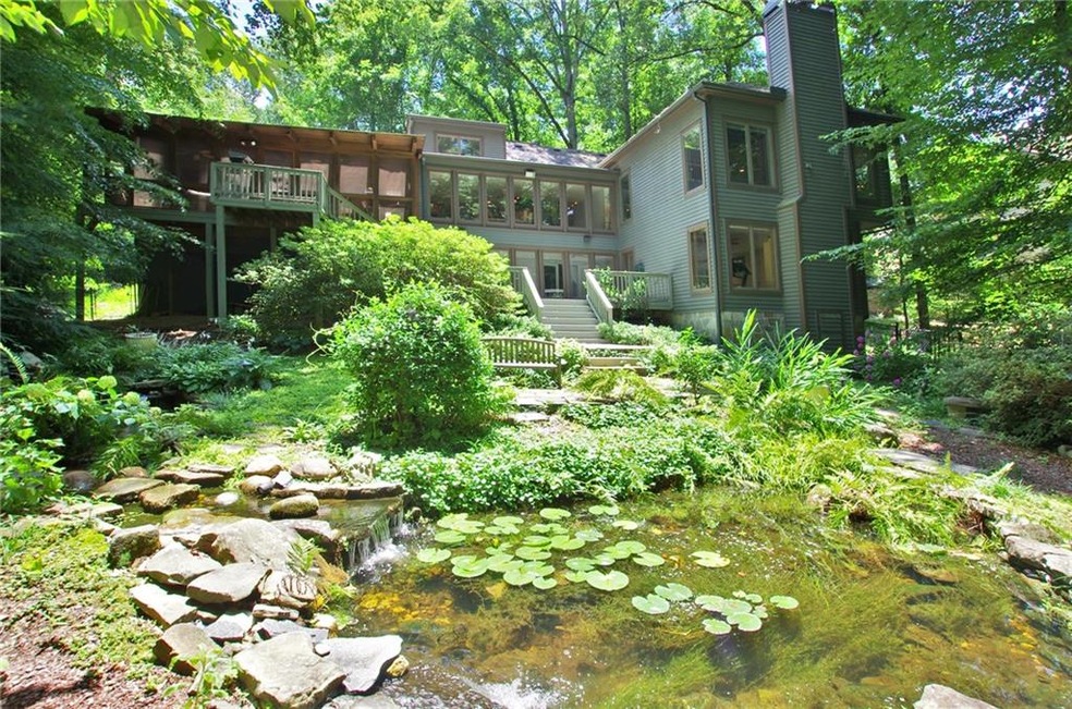 Back of home, with pond and walkway leading to dec
