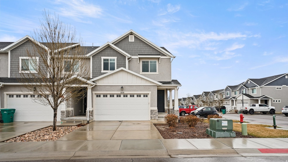 Craftsman-style house with board and batten siding, concrete driveway, stone siding, and a residential view