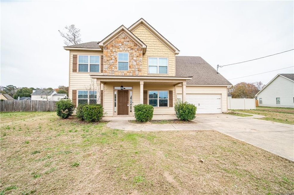 View of front of home featuring a garage and a front lawn
