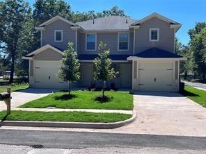 Traditional-style home with concrete driveway, a f