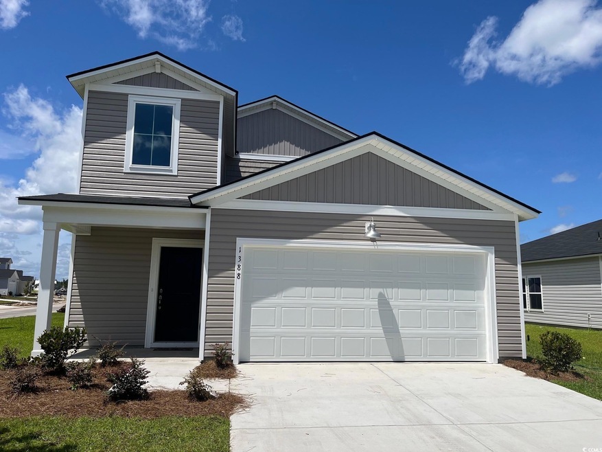 View of front facade featuring an attached garage and driveway
