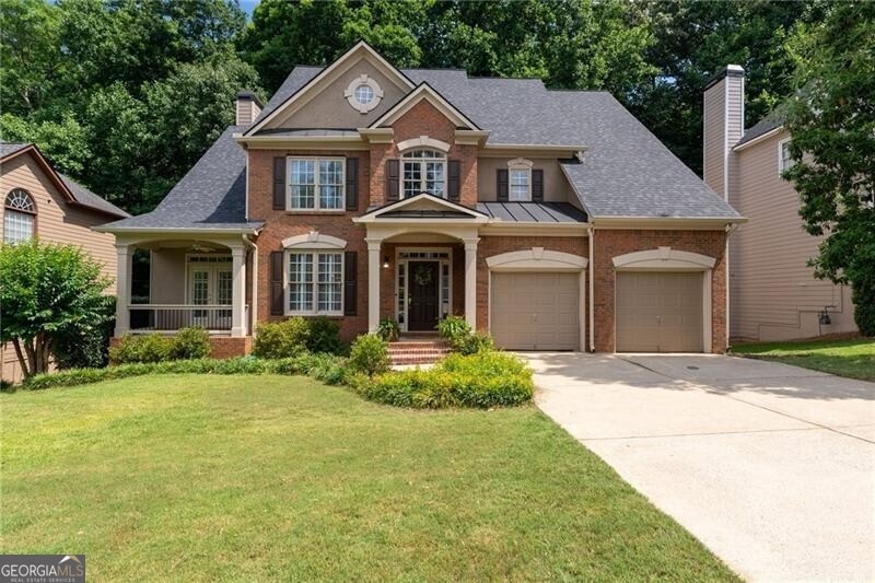 View of front of property featuring a garage and a
