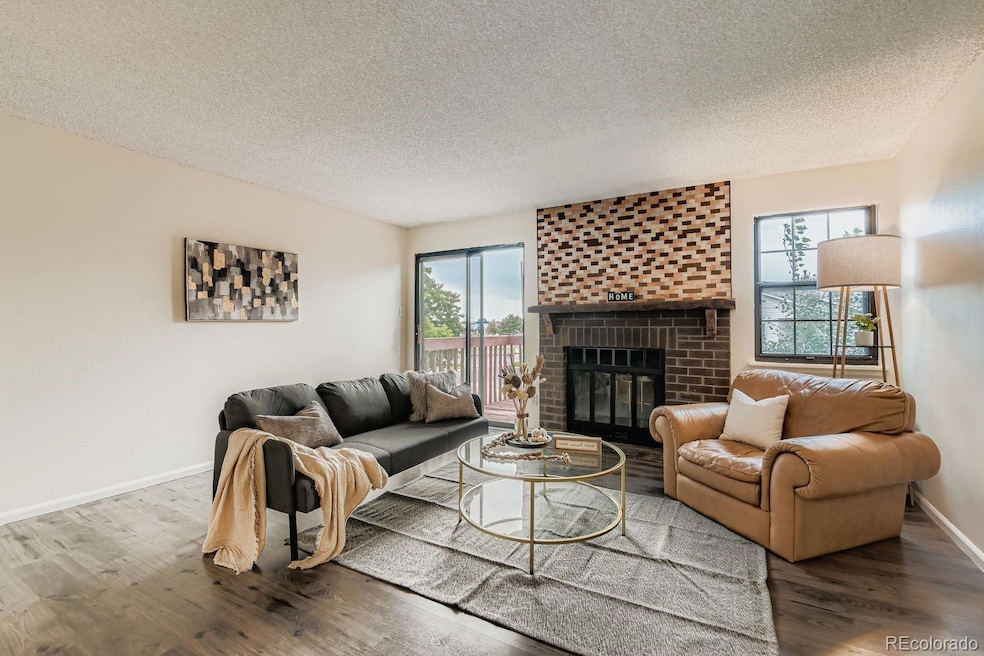 Open living room flooded with natural light and a cozy wood burning fireplace for the cooler nights.