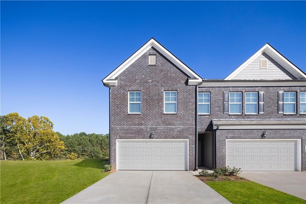 View of front of house with a front lawn and a gar