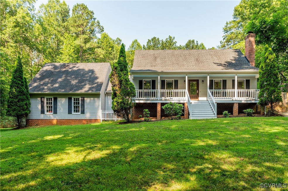 View of front facade with covered porch, a front y