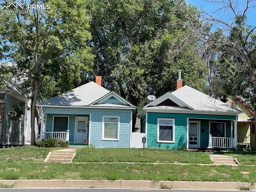 Bungalow-style house featuring covered porch, a front yard, a chimney, and roof with shingles