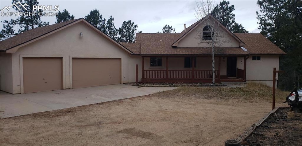 View of front of house with a garage and a porch