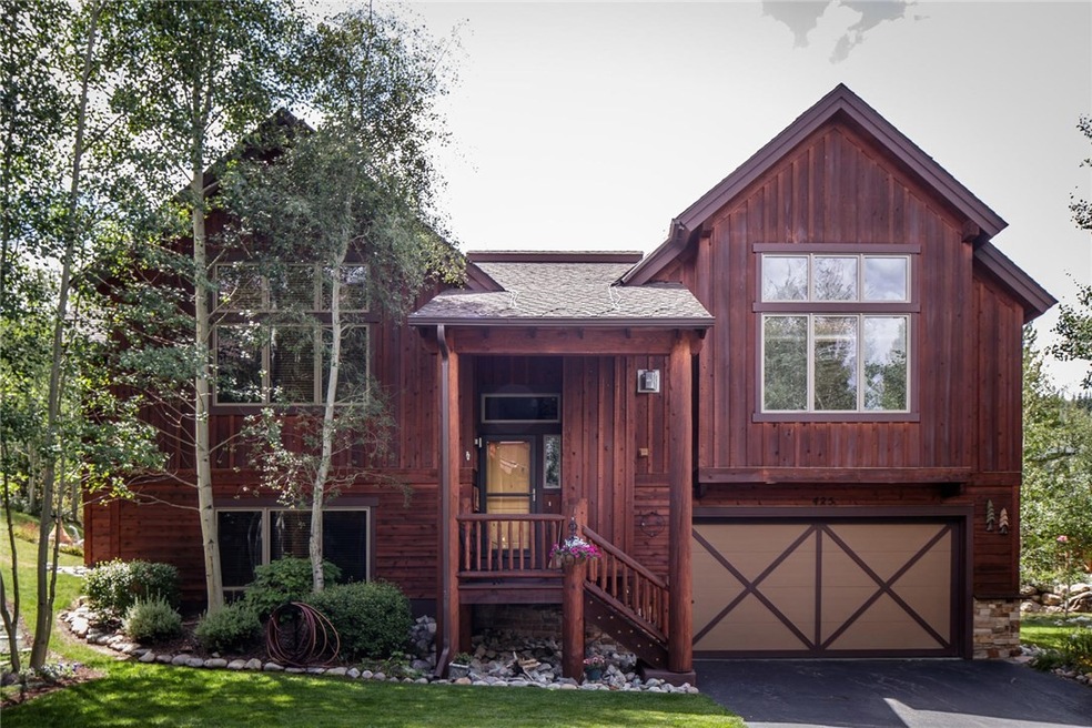 Beautiful gardens surround the entry to this home.