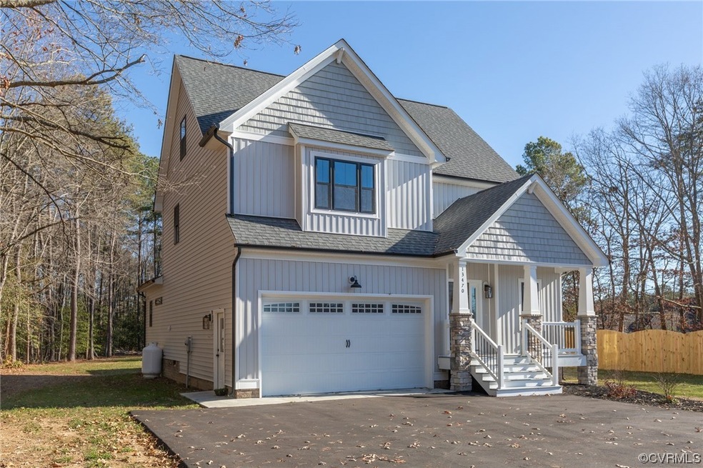 View of front of house with a porch and a garage