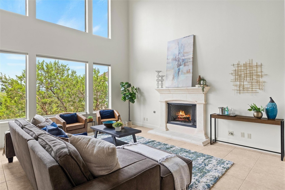 Tiled living area featuring a high ceiling and a 