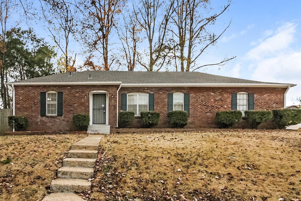 Ranch-style home featuring roof with shingles and brick siding